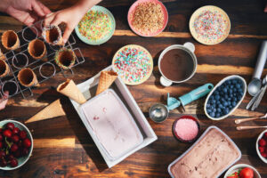 School’s Out For Summer! Homemade Ice Cream Ideas For The Holidays image 3 top view of sundae toppings with cones sprinkles and fresh fruit Frosted Fusions