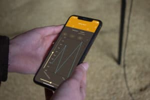 The Grainmaster i2 app shows detailed grain moisture and temperature readings.