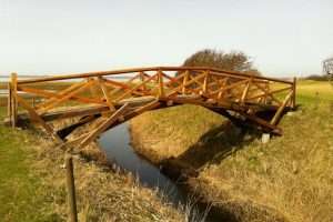 Wooden Da Vinci bridge across stream