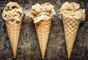 salivate-over-the-irresistible-charm-of-salted-caramel-ice-cream-image-3-jpeg-3-salted-caramel-ice-creams-in-cones-lined-up-dark-background-frosted-fusions
