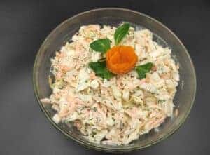 Chinese Cabbage Salad Recipe garnished with an orange flower in a bowl.