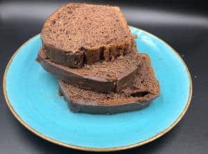 Three slices of chocolate bread on a blue plate, showcasing polish cuisine.