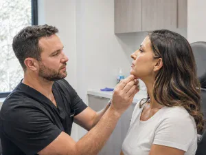 doctor checking her chin implant