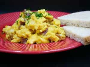 Polish Scrambled Eggs Recipe: Bacon and Toast on a Red Plate.