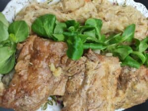 A plate of meat and vegetables showcasing the Polish cuisine.