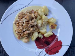 Polish Chanterelle Cream Sauce Recipe showcasing chicken and potatoes on a white plate.
