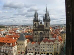 Aerial view of the Church of Our Lady before T&yacute;n with its twin spires, surrounded by red-roofed buildings in Prague's Old Town Square&mdash;an iconic sight for those seeking the best routes and travel options from Krakow to Prague.