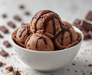 Irresistibly-Decadent-Homemade-Chocolate-Ice-Cream-image-7-bowl-of-chocolate-ice-cream-drizzled-with-chocolate-sauce-with-pieces-of-choc-to-the-side frosted fusions Irresistibly-Decadent-Homemade-Chocolate-Ice-Cream-image-7-bowl-of-chocolate-ice-cream-drizzled-with-chocolate-sauce-with-pieces-of-choc-to-the-side frosted fusions