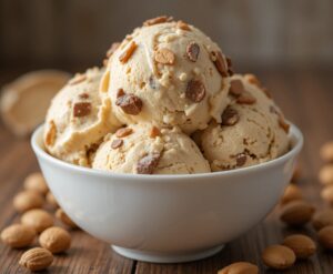 From Marathon To Snickers - A Homemade Recipe For Ice Cream Lovers! image 8 bowl of snickers ice cream with peanuts to the side frosted fusions