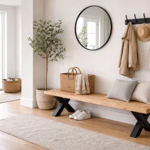Solid Swedish pine bench with black metal X legs in modern cosy entrance hallway