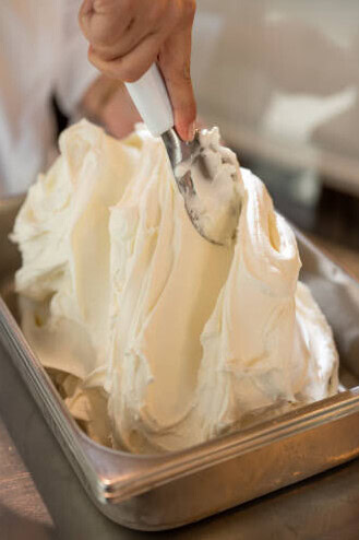 Mastering Homemade Gelato - A Beginner’s Guide To Italy’s Sweetest Tradition image 6 vanilla geltao being layered into silver tray frosted fusions