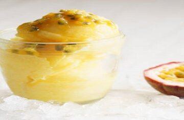 Passion-Fruit-Sorbet-A-Sweet-and-Tangy-Tropical-Dessert-featured-image-200x600w-passion-fruit-sorbet-in-glass-dish-with-half-a-passion-fruit-to-the-side-on-ice-frosted-fusions
