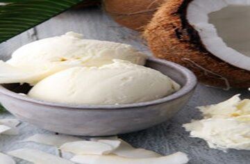 Homemade-Coconut-Ice-Cream-Recipe-featured-image-200x600w-dish-of-coconut-ice-cream-with-coconut-shavings-and-half-a-coconut-to-the-side-frosted-fusions