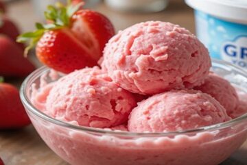 A-Healthy-Homemade-Strawberry-Frozen-Yoghurt-featured-image-strawberry-froyo-in-glass-dish-with-Greek Yoghurt and fresh-strawberries-scattered-frosted-fusions