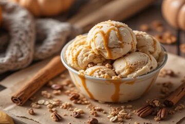 Sugar-and-Spice-and-All-Things-ICE-featured-image-pumpkin-spice-ice-cream-with-caramel-drizzle-pecans-and-cinnamon-sticks-surrounded-by-mini-pumpkins-Frosted-Fusions