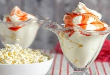 Is-Viral-Cottage-Cheese-Ice-Cream-Worth-All-The-Hype-featured-image-207x620w-Strawberry-ice-cream-in-dessert-glasses-with-a-bowl-of-cottage-cheese-Frosted-Fusions