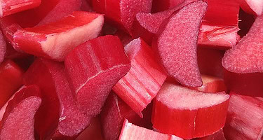 Homemade Rhubarb Ice Cream A Truly Tantalisingly Tangy Treat! image 2 vibrant red rhubarb chunks in a pile frosted fusions