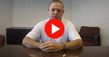Screenshot of PLAY button on customer testimonial video