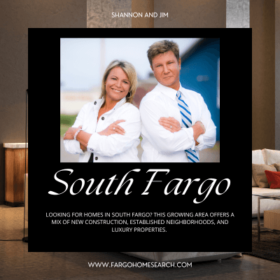 Shannon and Jim, real estate agents, standing confidently with arms crossed in front of a modern building. The image promotes South Fargo homes for sale, highlighting new construction, established neighborhoods, and luxury properties. Website: www.fargohomesearch.com
