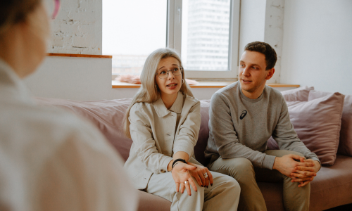 A couples therapy session in Langley with a therapist from Darcy Bailey & Associates guiding partners through open communication and emotional connection exercises.