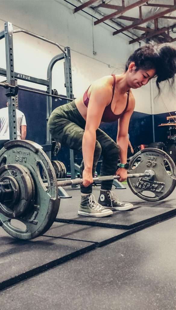 Woman performing a deadlift exercise at a Boise, Idaho gym.