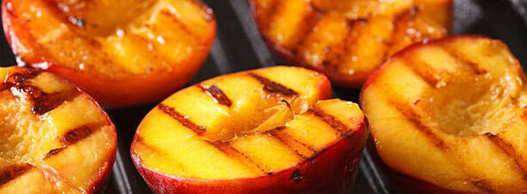 Homemade Ice Cream Hacks You Need To Know image 3 roasted peach halves with griddle marks on flesh frosted fusions