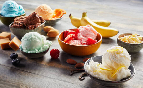 Mastering Homemade Gelato - A Beginner’s Guide To Italy’s Sweetest Tradition image 7 bowls of gelato with fresh fruit and chocolate toppings frosted fusions