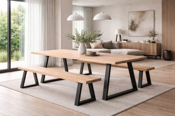 Modern dining and living area featuring a solid ash table with matt black steel legs and coordinating wooden benches