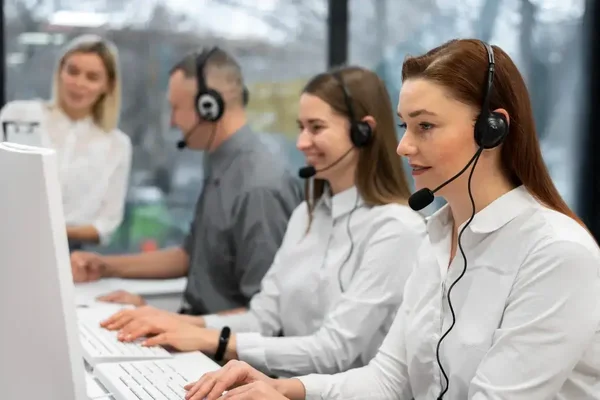 Dynamic team collaborating in a bright, modern call center workspace.
