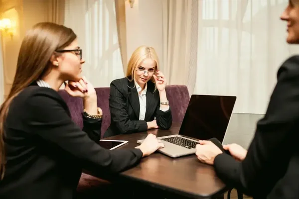 Team collaborating in a modern office, engaging in productive business discussions with professional attire.