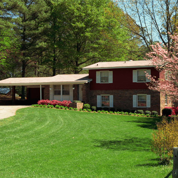 Spacious bi-level home with a split-entry design, large windows, and a well-maintained front yard in a suburban neighborhood