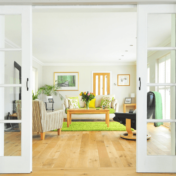Bright and modern living room with sliding glass doors, wood flooring, and cozy seating—typical of rambler-style homes in West Fargo, Fargo, Horace, and Moorhead.