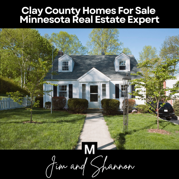 Banner featuring a classic single-family home with a manicured front yard and overlaid text &ldquo;Clay County Homes For Sale&ensp;Minnesota Real Estate Expert&rdquo; above, plus the &ldquo;M&rdquo; logo and &ldquo;Jim and Shannon&rdquo; signature below