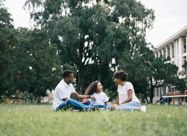family-sitting-in-grass