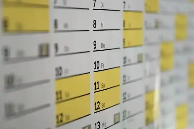 Close-up of a wall calendar with highlighted dates.