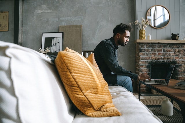 man-sitting-on-couch-by-himself