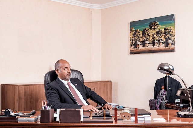 man-of-color-sitting-at-his-office-desk