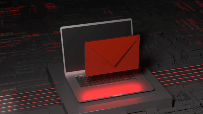 A laptop with a red email on top. The red email seems suspicious.