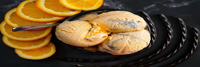 Tiger-Tail-Ice-Cream-The-Sweet-And-Bold-Canadian-Classic-featured-image-830x2450w-top-view-of-orange-ice-cream-with-swirls-of-black-with-licorice-and-fresh-orange-slices-frosted-fusions