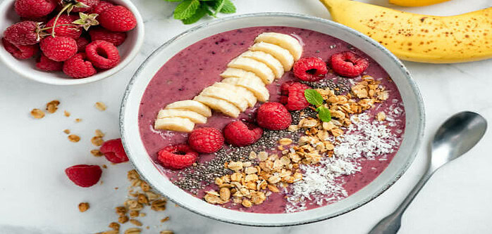 a-delicious-and-nutrient-packed-berry-blast-smoothie-image-8-smoothie-bowl-red-smoothie-with-additiona-chopped-and-sliced-fruit-and-seeds-and-grains-frosted-fusions