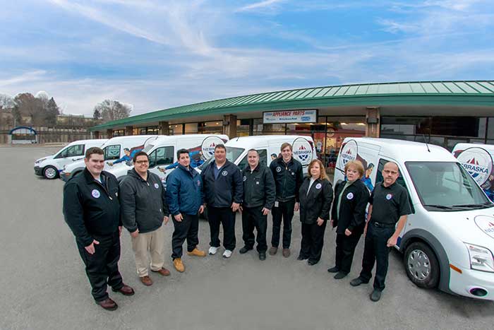Hometown Hero Appliance Repair Repair technician team in front of branded trucks