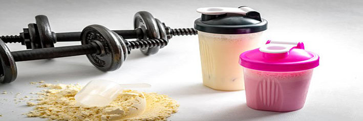 Protein-Shake-Fusions-Creating-Protein-Rich-Low-Fat-Homemade-Ice-Cream-featured-image-200x600w-pair-of-dumbells-two-protein-shakes-and-protein-powder-scattered-with-scoop-frosted-fusions