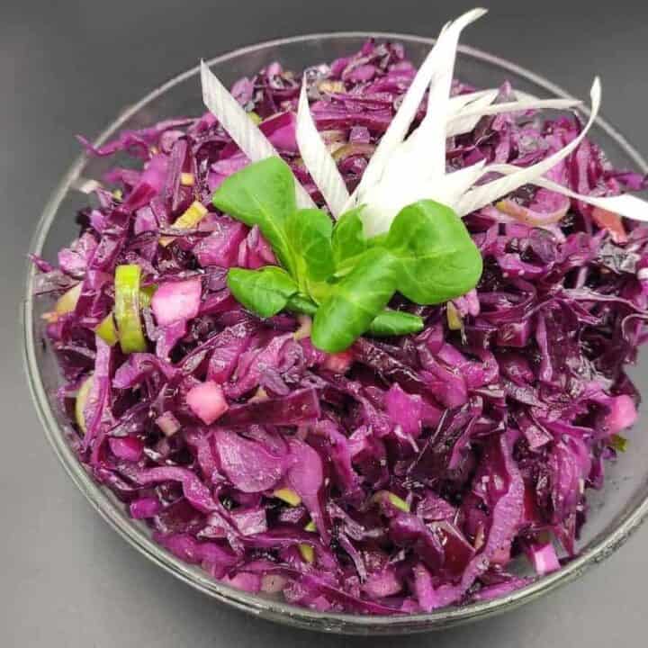 A Polish red cabbage salad recipe displayed on a black surface.