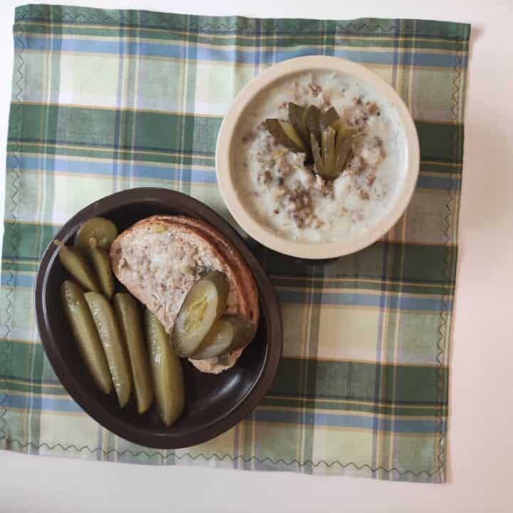 A table with a bowl of soup and bread in Smarowidło - Polish Spread.