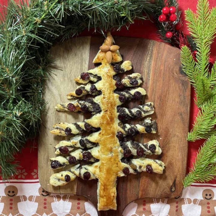 A Poppyseed Christmas tree cake on a cutting board.