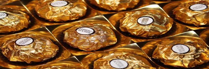Ferrero-Rocher-Lovers-This-Homemade-Ice-Cream-Recipe-Is-For-You-Featured-Image-637x1920w-close-up-of-tray-of-Ferrero-Rocher-in-gold-wrapping-Frosted-Fusions