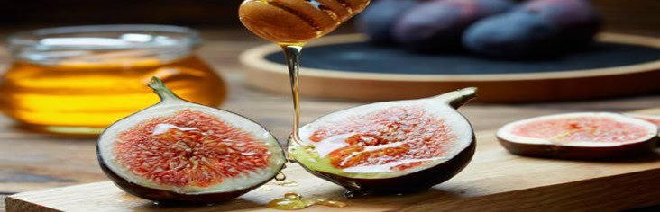 Homemade-Fig-And-Honey-Ice-Cream-Recipe-featured-image-cropped-200x620w-fig-sliced-in-half-with-honey-drizzling-over-the-fig-jar-of-honey-and-figs-in-background-frosted-fusions