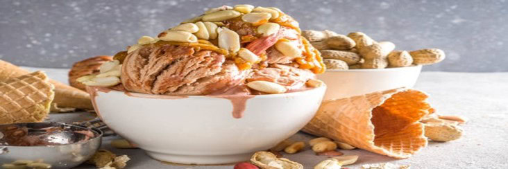 A-Homemade-Peanut-Butter-Ice-Cream-featured-image-cropped-207x620w-white-bowl-of-peanut-butter-ice-cream-with-lots-of-shelled-peanuts-around-frosted-fusions