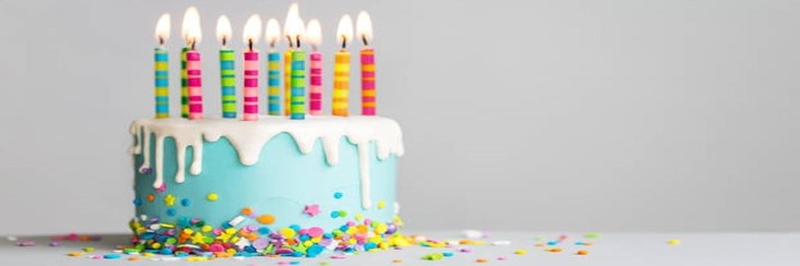 Homemade-Birthday-Cake-Ice-Cream-Recipe-featured-image-207x620w-decorated-birthday-cake-with-icing-and-sprinkles-around-the-bottom-and-several-candles-lit-frosted-fusions