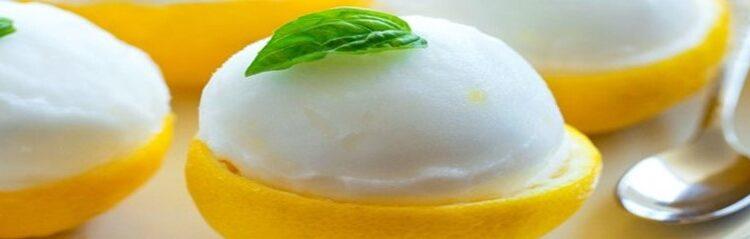 Luscious-Lemon-Sorbet-Zesty-Citrus-Bliss-featured-632x2000w-jpeg-lemon-sorbet-in-lemon-shell-with-basil-leaf-on-top-frosted-fusions
